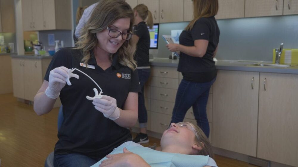 Amazing Smiles staff working with a patient