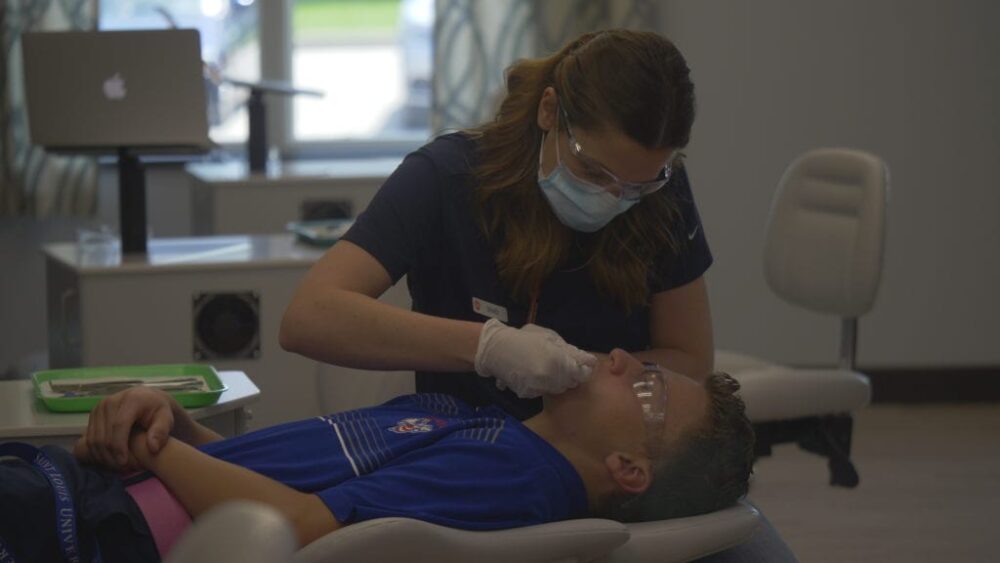 Amazing Smiles staff working with a patient